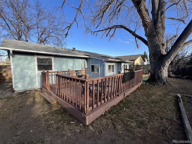 back of house with a deck and fence