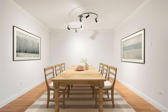 695 S Alton Way Unit 9C, Denver, CO 80247 - dining area featuring crown molding, light wood-style flooring, and track lighting