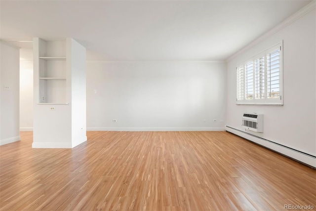 695 S Alton Way Unit 9C, Denver, CO 80247 - spare room featuring crown molding, light wood-style floors, a baseboard radiator, and a wall unit AC