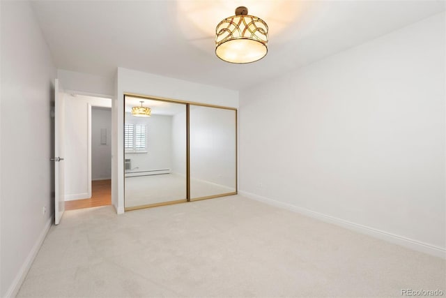 695 S Alton Way Unit 9C, Denver, CO 80247 - unfurnished bedroom featuring light colored carpet, a closet, and baseboard heating