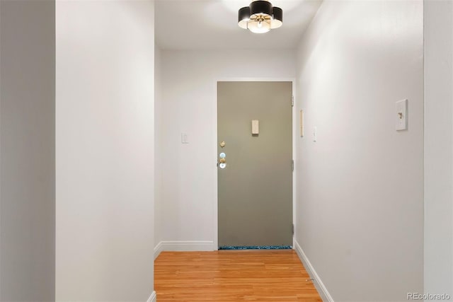 695 S Alton Way Unit 9C, Denver, CO 80247 - doorway with light wood-style floors and baseboards