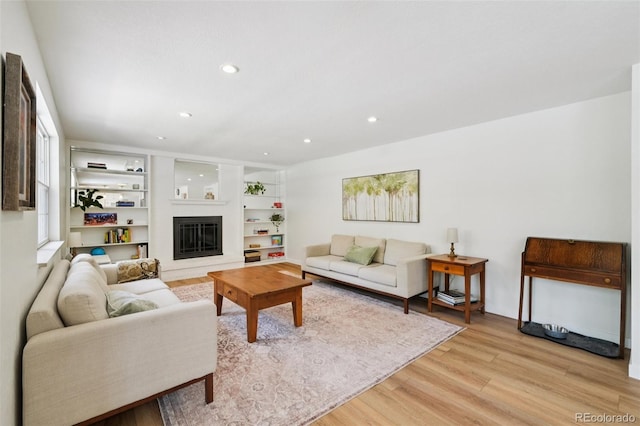 841 Beech St, Golden, CO 80401 - living room with light wood-type flooring, a glass covered fireplace, recessed lighting, and built in shelves