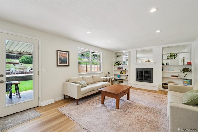 841 Beech St, Golden, CO 80401 - living room featuring light wood finished floors, plenty of natural light, a glass covered fireplace, and recessed lighting