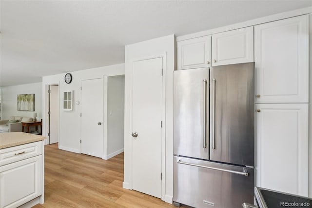 841 Beech St, Golden, CO 80401 - kitchen featuring high end refrigerator, light wood-style flooring, white cabinetry, light countertops, and range
