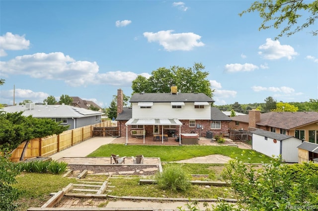 841 Beech St, Golden, CO 80401 - back of house featuring a patio, a fenced backyard, a storage unit, and brick siding