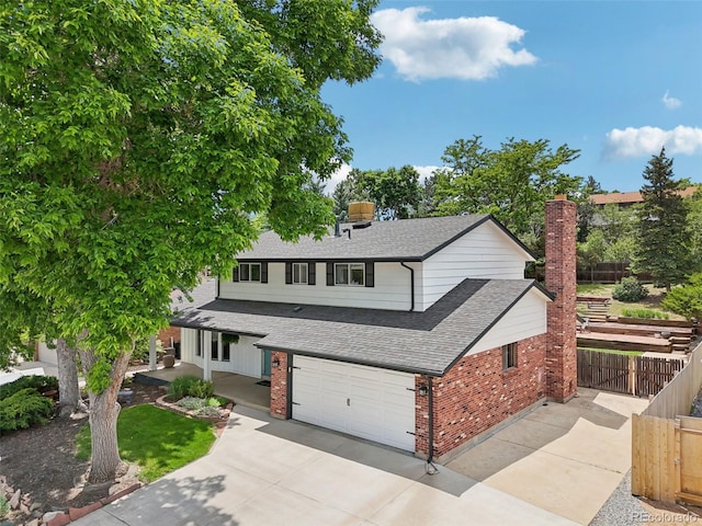 841 Beech St, Golden, CO 80401 - traditional-style house featuring brick siding, a shingled roof, an attached garage, and driveway