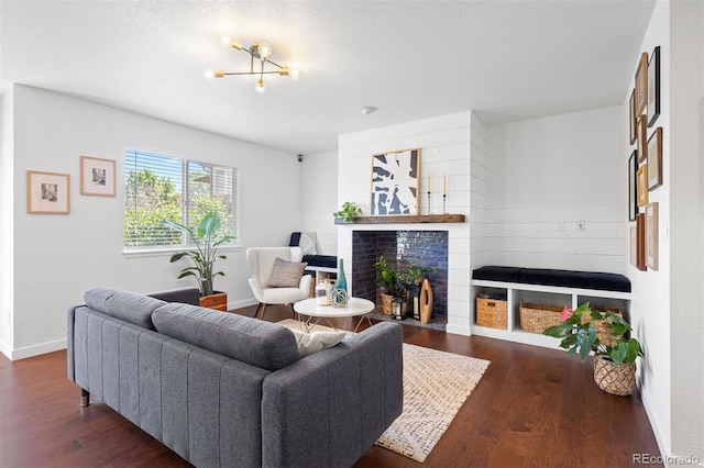 3357 Holly Hock Ct, Castle Rock, CO 80109 - living area with a tile fireplace, dark wood-style floors, and a chandelier