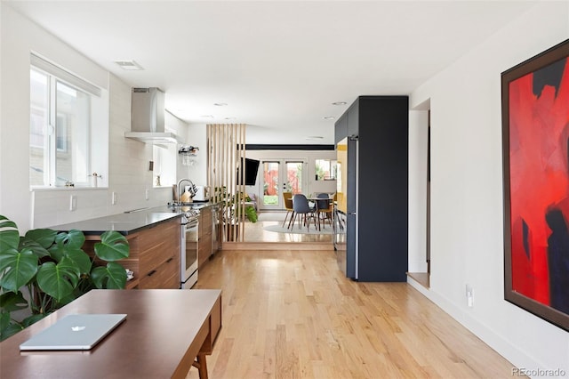 401 S Ivy St, Denver, CO 80224 - kitchen with light wood-style floors, wall chimney range hood, a sink, and modern cabinets