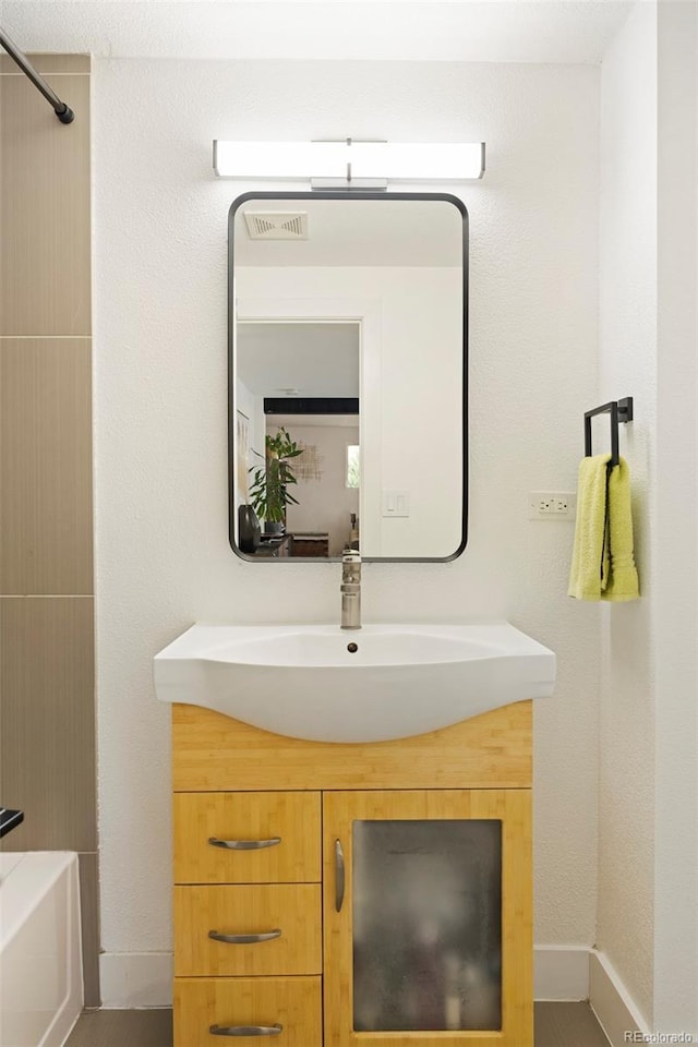 401 S Ivy St, Denver, CO 80224 - bathroom featuring vanity, baseboards, and a tub