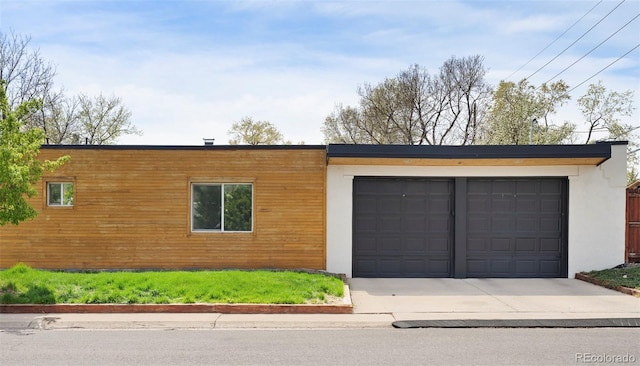 401 S Ivy St, Denver, CO 80224 - view of front of house with driveway, a garage, and stucco siding
