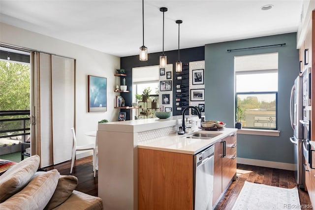 3420 W 32nd Ave Unit 203, Denver, CO 80211 - kitchen with dishwasher, healthy amount of natural light, a kitchen island with sink, and light countertops