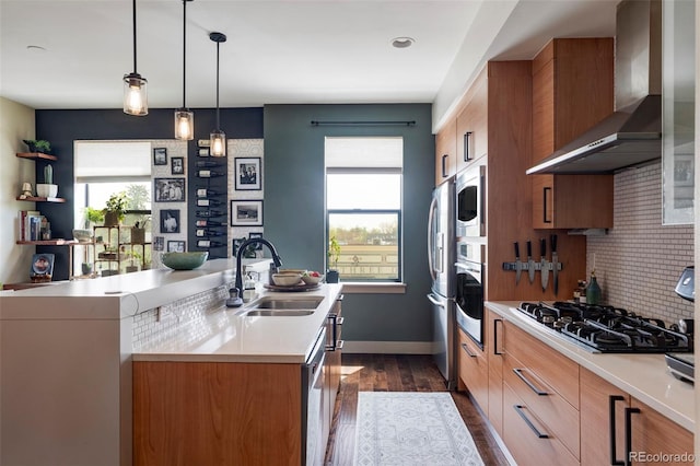 3420 W 32nd Ave Unit 203, Denver, CO 80211 - kitchen with wall chimney range hood, appliances with stainless steel finishes, brown cabinetry, and light countertops