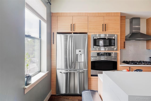 3420 W 32nd Ave Unit 203, Denver, CO 80211 - kitchen featuring appliances with stainless steel finishes, wall chimney range hood, decorative backsplash, dark wood-style floors, and light countertops