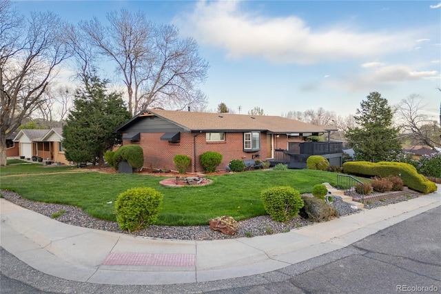 ranch-style home featuring brick siding and a front lawn