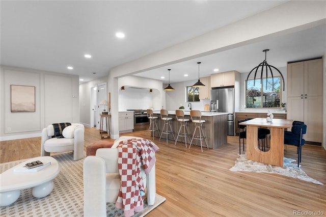 living area featuring light wood-style floors and recessed lighting