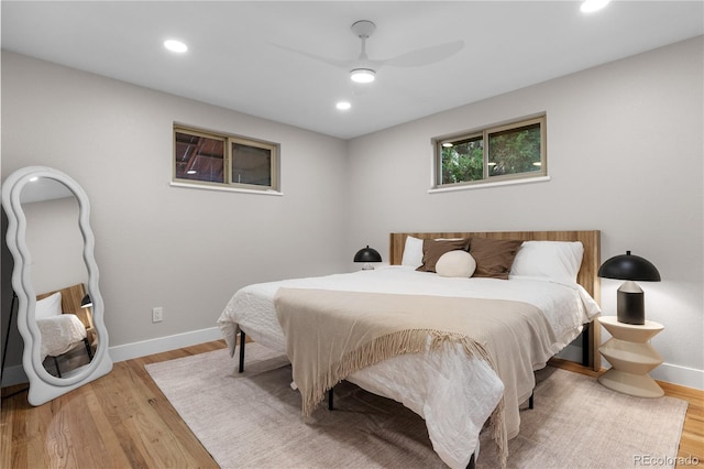 bedroom with recessed lighting, baseboards, and light wood finished floors