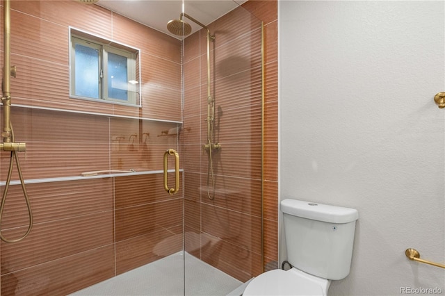full bath featuring a stall shower and toilet