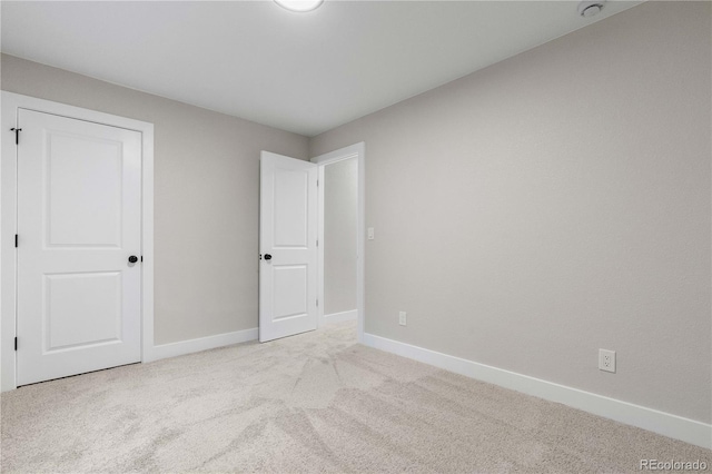 unfurnished bedroom with carpet floors and baseboards