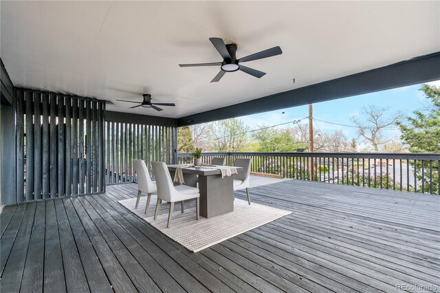 wooden deck featuring outdoor dining area and a ceiling fan