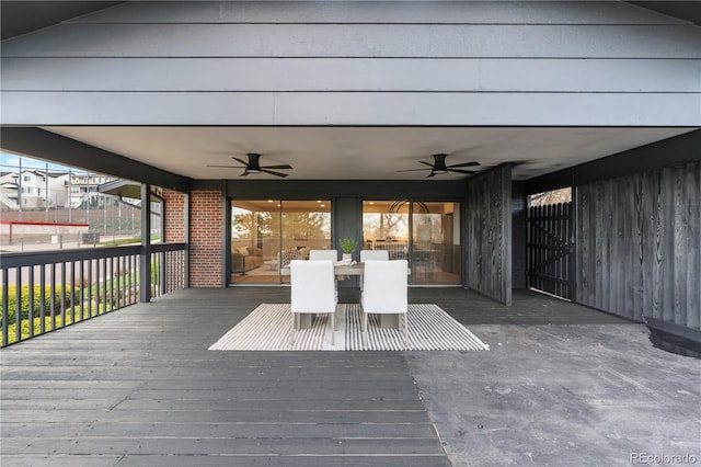 wooden terrace with ceiling fan and outdoor dining area
