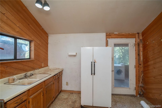 bathroom with vanity, washer / clothes dryer, and wooden walls