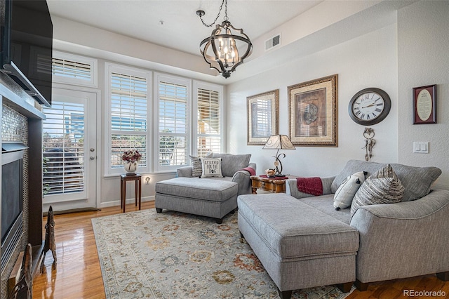 living room featuring light hardwood / wood-style flooring and a notable chandelier