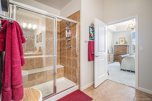 bathroom featuring a shower with door, a notable chandelier, and tile patterned flooring