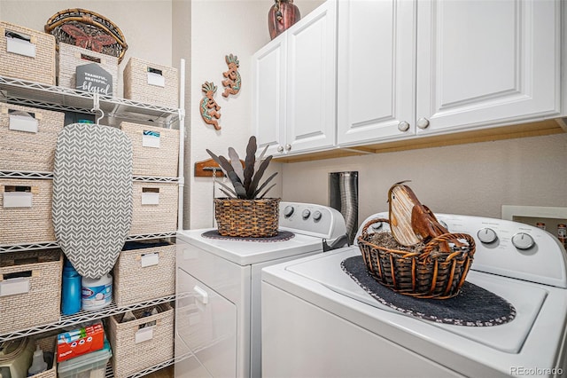 washroom with cabinets and washer and clothes dryer