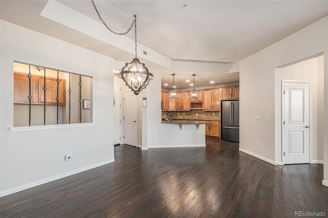 7865 Vallagio Ln Unit 308, Englewood, CO 80112 - unfurnished living room featuring a chandelier, dark wood-style flooring, and recessed lighting