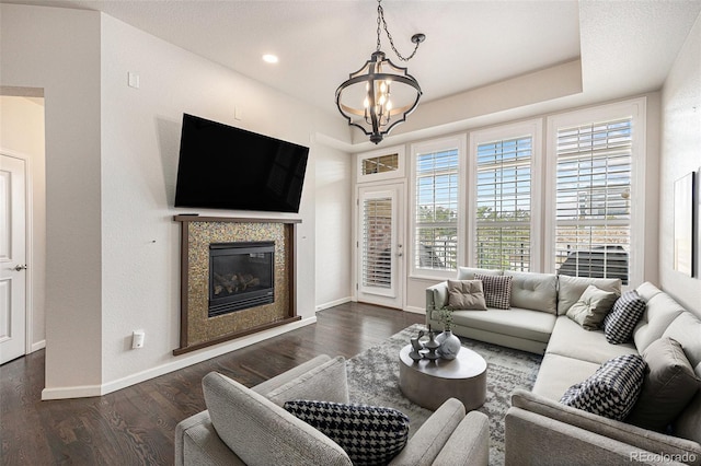 7865 Vallagio Ln Unit 308, Englewood, CO 80112 - living room with a chandelier, dark wood-style flooring, and a glass covered fireplace