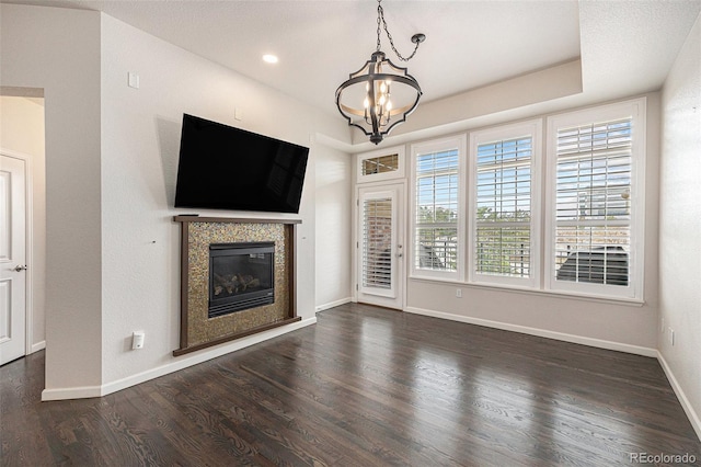 7865 Vallagio Ln Unit 308, Englewood, CO 80112 - unfurnished living room featuring a chandelier, wood finished floors, and a glass covered fireplace