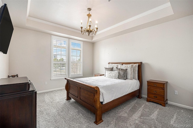 7865 Vallagio Ln Unit 308, Englewood, CO 80112 - carpeted bedroom featuring a tray ceiling, ornamental molding, and a chandelier