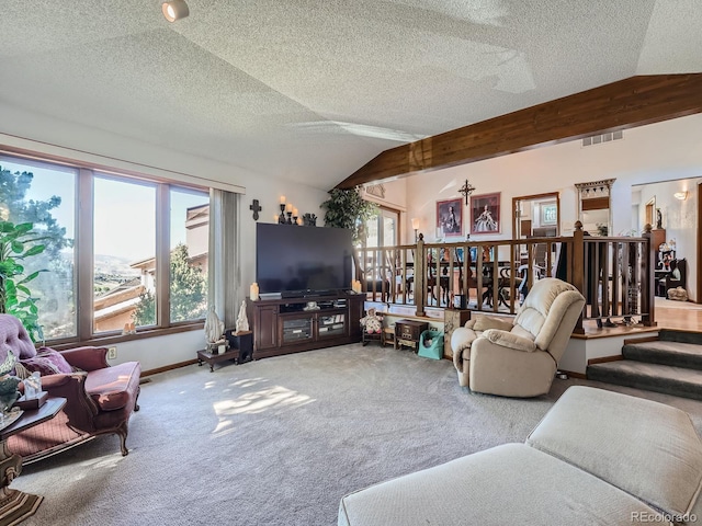 carpeted living room with a textured ceiling and lofted ceiling