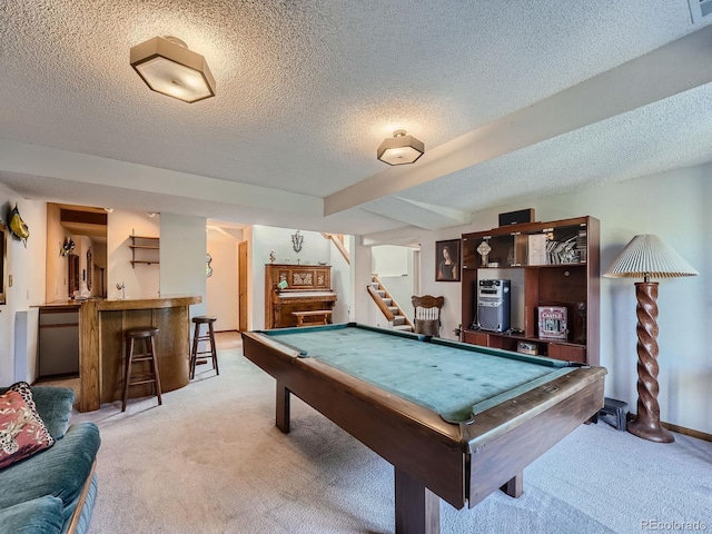 rec room with bar, light colored carpet, a textured ceiling, and billiards