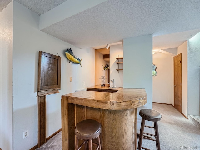 bar with a textured ceiling and light carpet