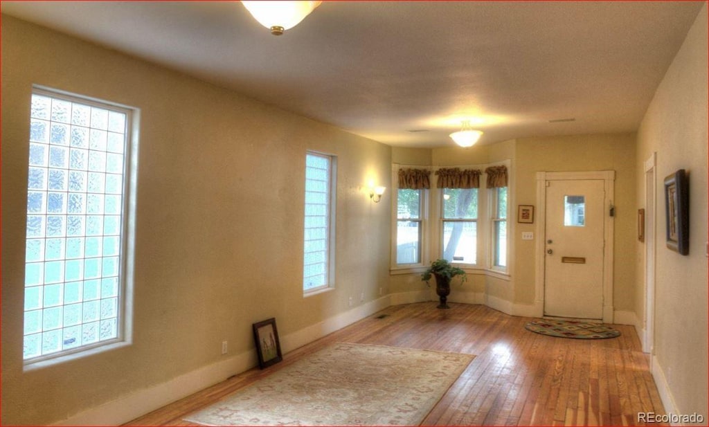 426 E Bijou St, Colorado Springs, CO 80903 - entryway featuring healthy amount of natural light, wood-type flooring, and baseboards