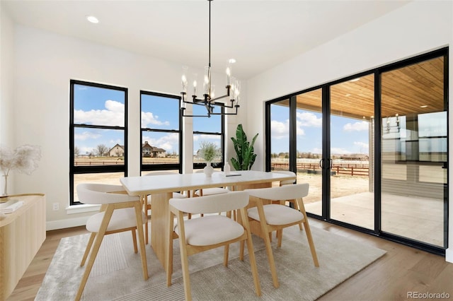 1877 Spring Bloom Dr, Windsor, CO 80550 - dining room with baseboards, an inviting chandelier, light wood-style flooring, and recessed lighting