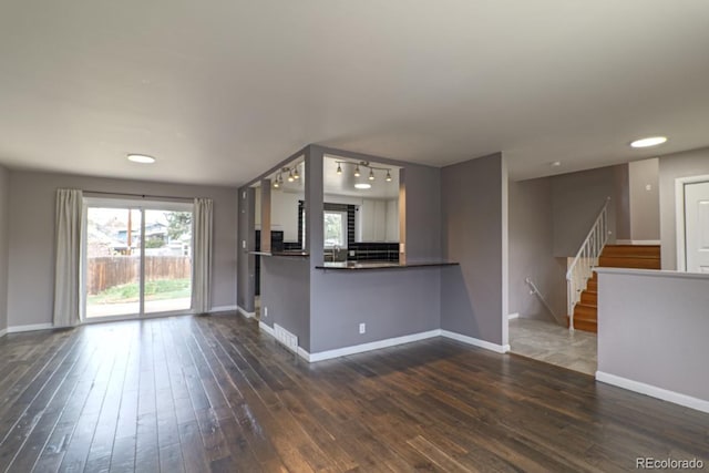 kitchen featuring baseboards, recessed lighting, dark wood-style floors, and dark countertops