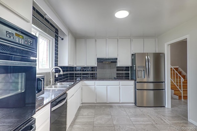 kitchen featuring under cabinet range hood, appliances with stainless steel finishes, decorative backsplash, and a sink
