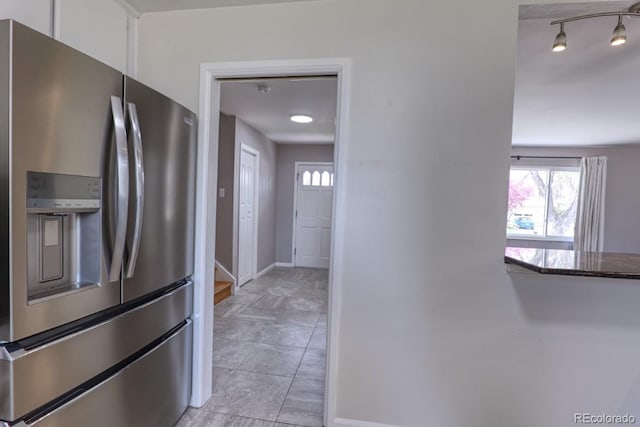 kitchen featuring baseboards, white cabinetry, and stainless steel fridge with ice dispenser