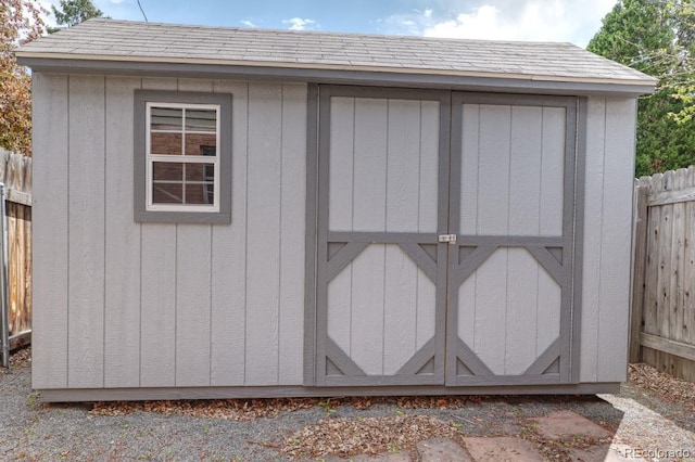 view of shed with fence