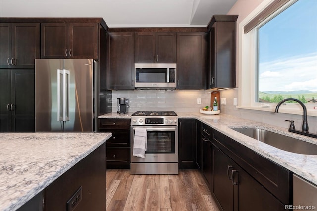 251 Grand Elk Way, Granby, CO 80446 - kitchen with appliances with stainless steel finishes, healthy amount of natural light, light wood-style floors, and light stone countertops