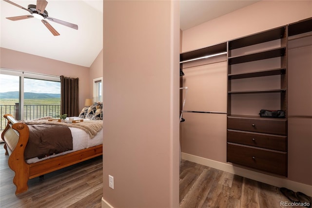 251 Grand Elk Way, Granby, CO 80446 - bedroom with access to exterior, wood finished floors, vaulted ceiling, and a ceiling fan