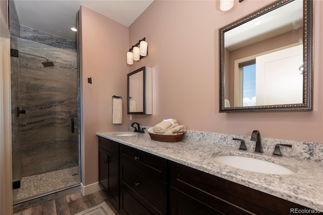 251 Grand Elk Way, Granby, CO 80446 - bathroom with wood finished floors, a stall shower, and double vanity