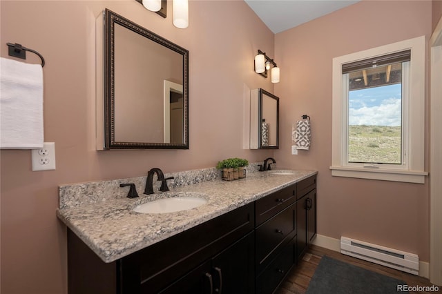 251 Grand Elk Way, Granby, CO 80446 - full bath featuring a baseboard radiator, double vanity, and wood finished floors
