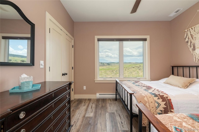 251 Grand Elk Way, Granby, CO 80446 - bedroom with a baseboard radiator, wood finished floors, and a ceiling fan