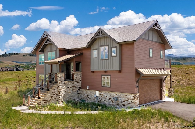 251 Grand Elk Way, Granby, CO 80446 - craftsman-style house with an attached garage, board and batten siding, roof with shingles, and driveway