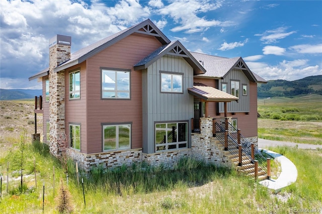 251 Grand Elk Way, Granby, CO 80446 - view of front of property with a chimney, stone siding, board and batten siding, and a mountain view