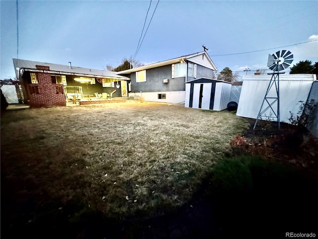back of property featuring a storage unit and an outbuilding