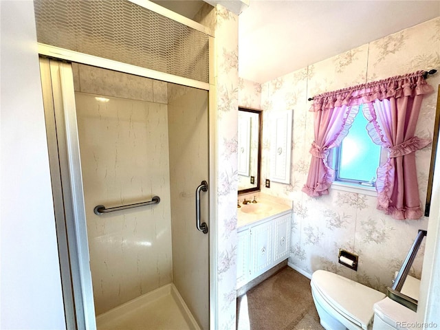 full bath featuring wallpapered walls, vanity, a shower stall, and toilet